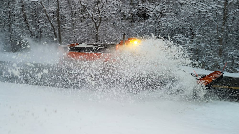 A plow clears Elk Creek Road after sveral inches of snow fell Tuesday, Dec. 2, 2025 in Madison Township in Butler County. NICK GRAHAM/STAFF