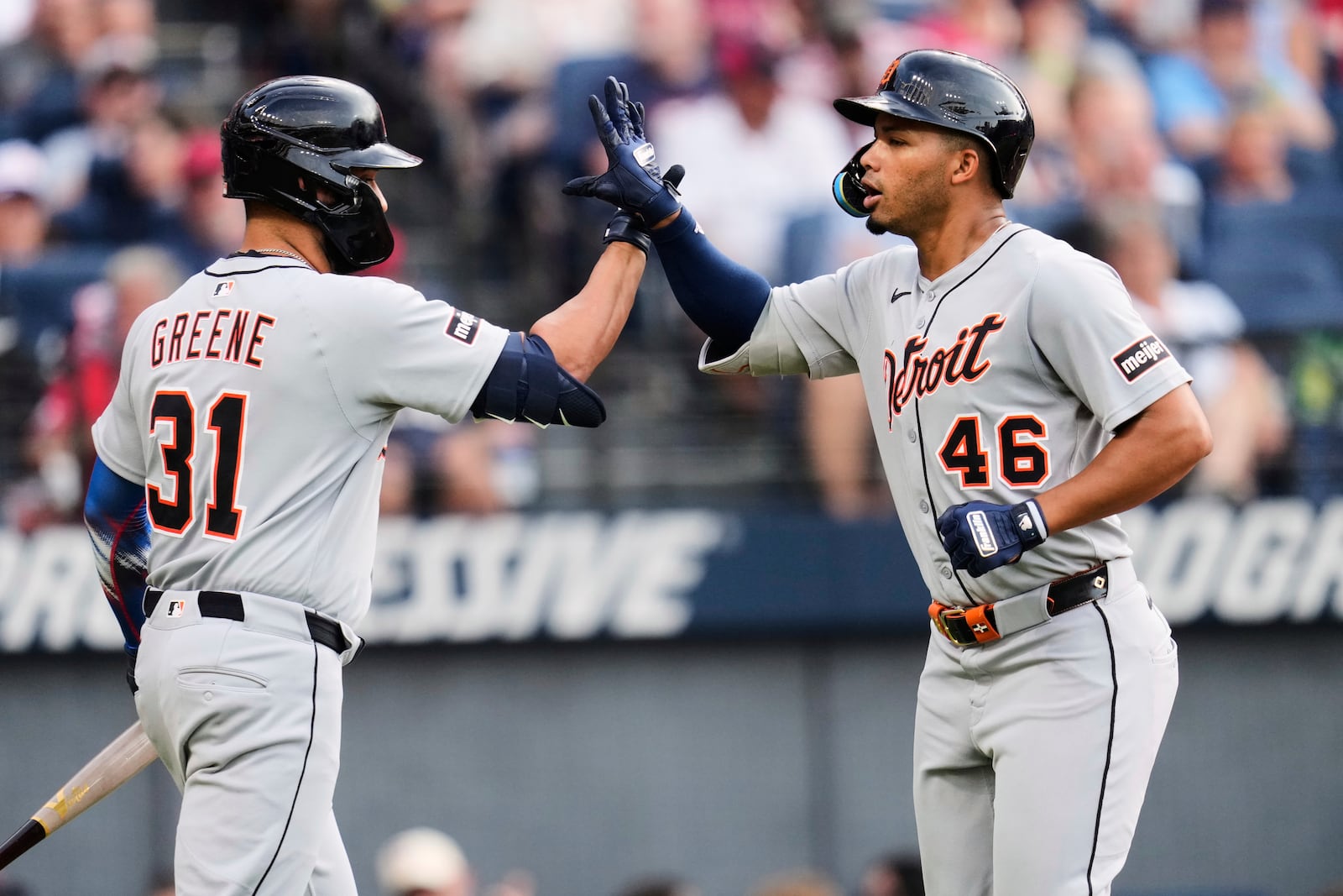 Detroit Tigers' Wenceel Pérez (46) is congratulated by teammate Riley Greene (31) after hitting a home run in the third inning of a baseball game against the Cleveland Guardians in Cleveland, Friday, July 4, 2025. (AP Photo/Sue Ogrocki)