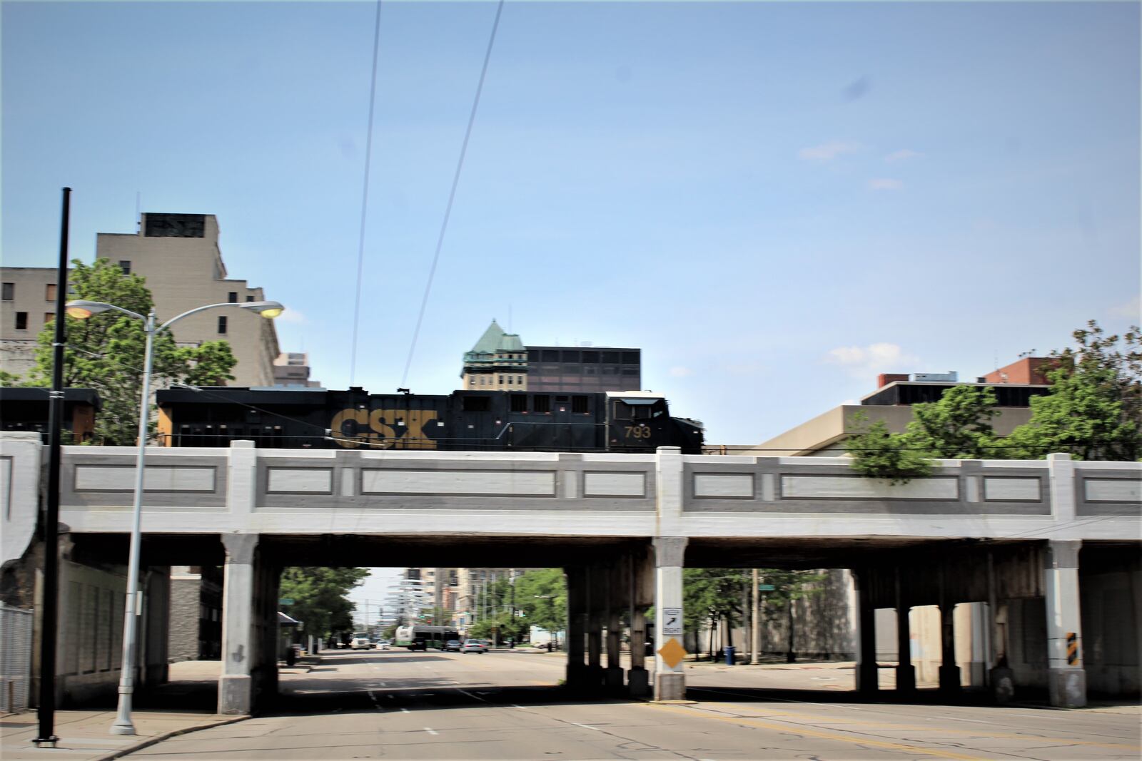 A CSX commercial train crosses an overpass on South Main Street in downtown Dayton.CORNELIUS FROLIK / STAFF