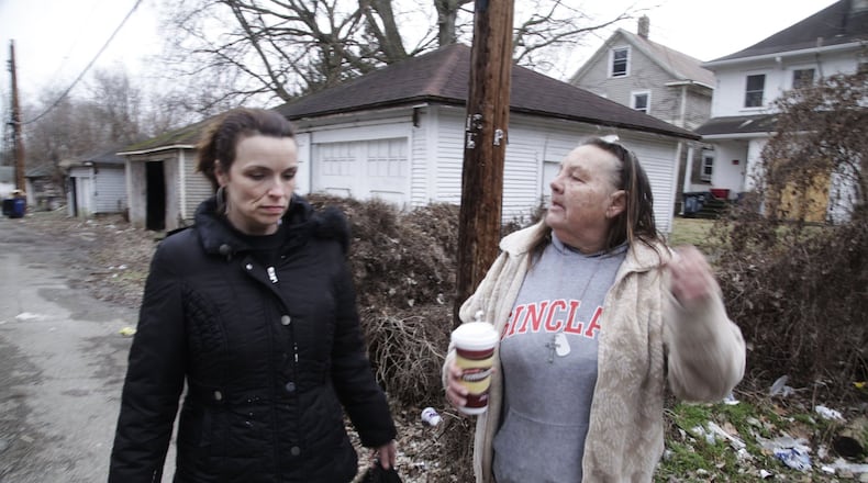 Victoria McNeal, president of the Riverdale Neighborhood Association and fellow neighborhood activist Lynn LaMance, of the Five Oaks neighborhood, patrol the alley between W. Hudson and Marathon streets in Dayton. The two women pick up trash, report open vacant structures, paint over graffiti and try to get property owners to take care of their property. STAFF Byron Stirsman
