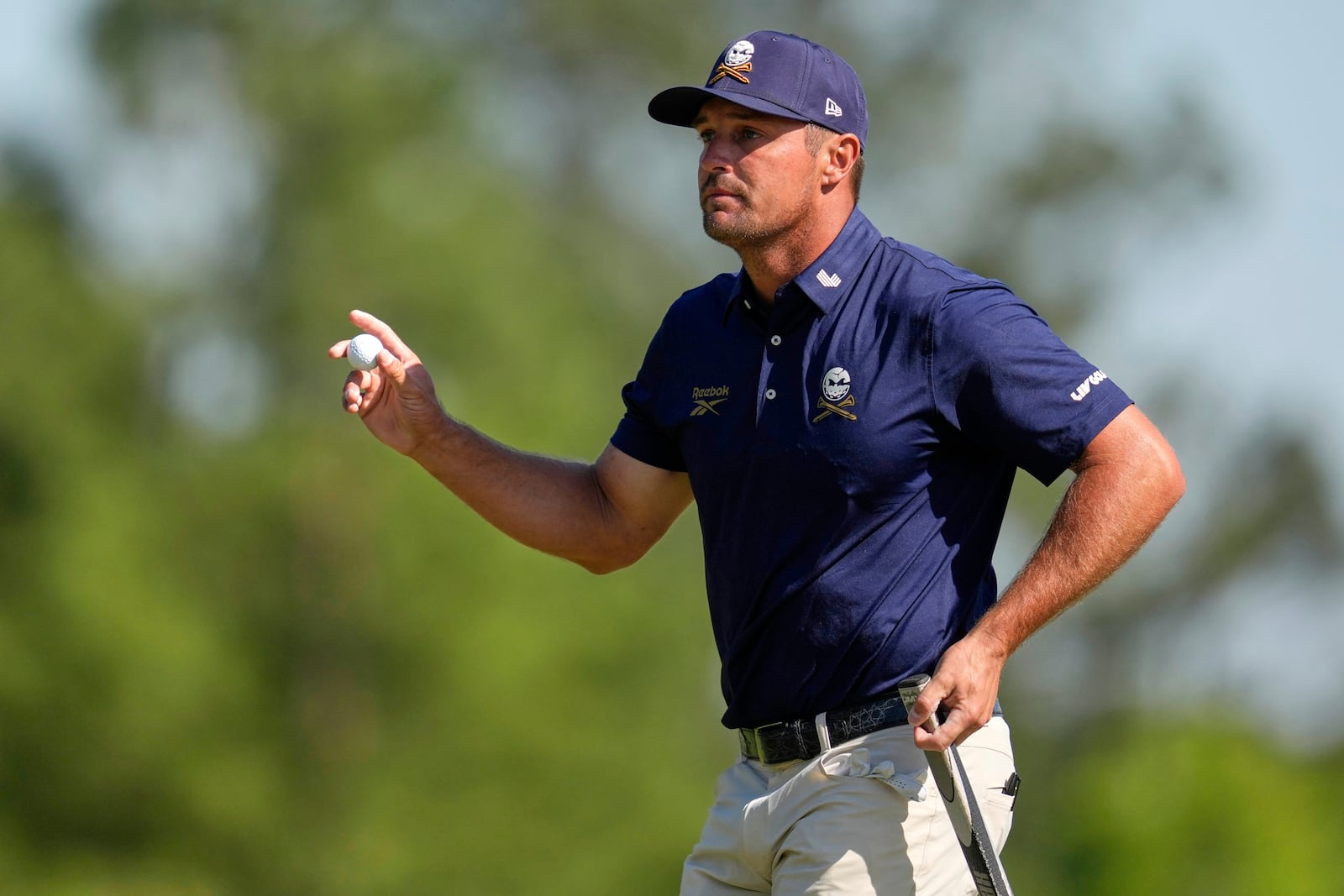 Bryson DeChambeau waves after making a putt on the eighth hole during the final round at the Masters golf tournament, Sunday, April 13, 2025, in Augusta, Ga. (AP Photo/Ashley Landis)