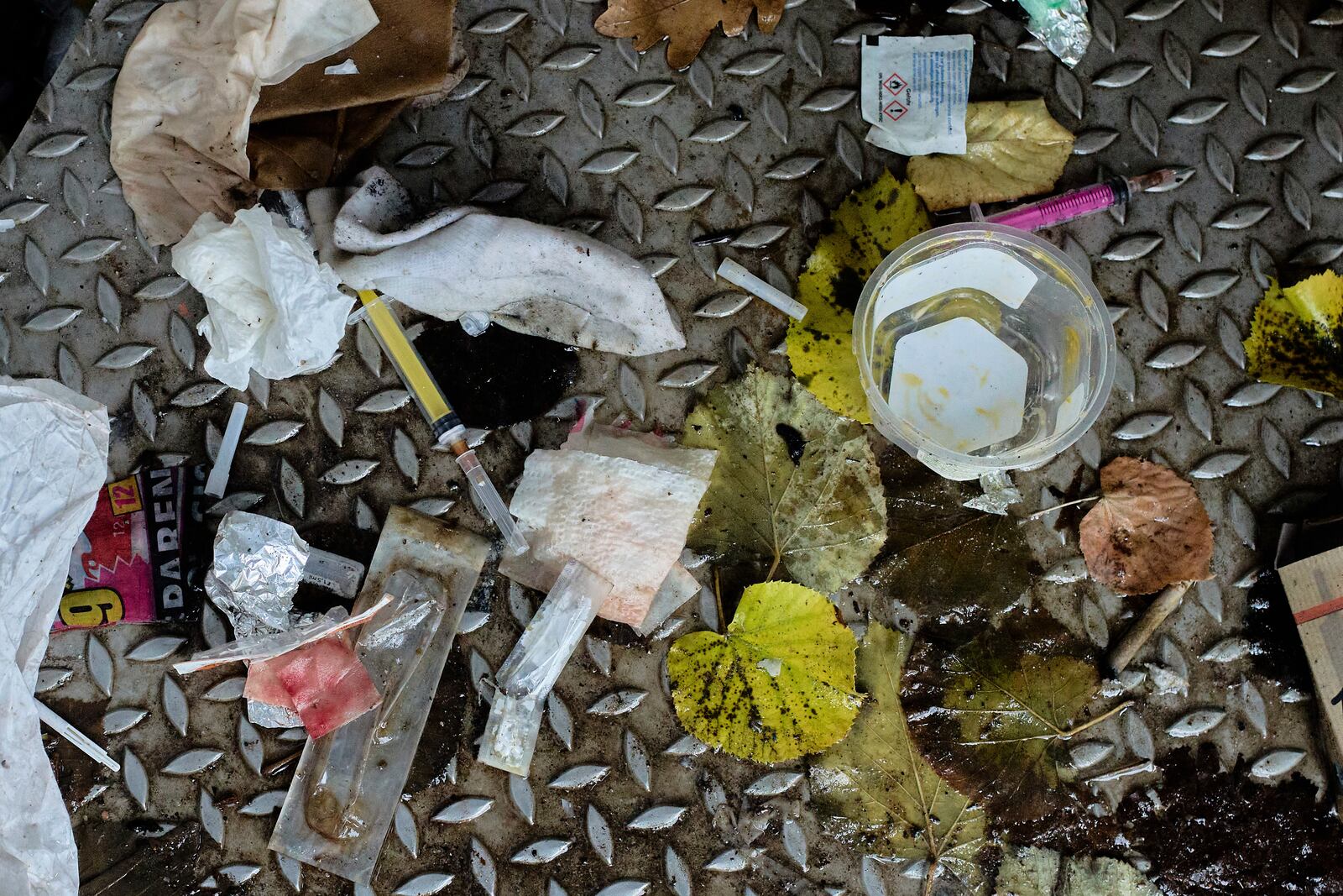 Used syringes and other drug paraphernalia lie on the floor of a public toilet in Berlin, Germany, Thursday, Nov. 21, 2024. (AP Photo/Markus Schreiber)