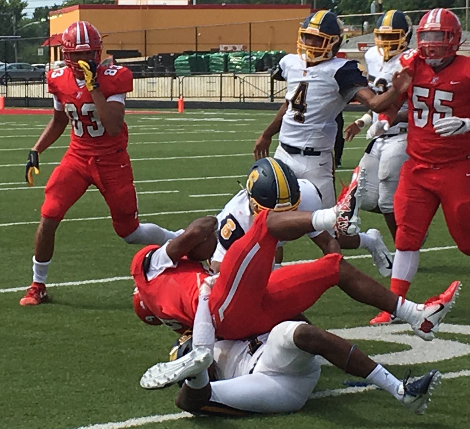 Fairfield’s JuTahn McClain (9) gets tackled by Springfield’s Jalen Minney (6) and C.J. McDavid during Saturday afternoon’s game at Fairfield Stadium. RICK CASSANO/STAFF