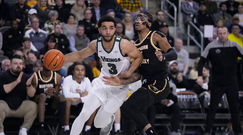 Cleveland State's Deshon Parker (3) goes to the basket against Northern Kentucky's Chris Brandon during the first half of an NCAA college basketball game for the Horizon League men's tournament championship Tuesday, March 7, 2023, in Indianapolis. (AP Photo/Darron Cummings)