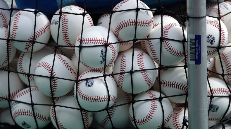 FILE - In this July 3, 2020, file photo, balls marked with Cactus League spring training logos are in a basket during Kansas City Royals baseball practice at Kauffman Stadium in Kansas City, Mo. Major League Baseball has slightly deadened its baseballs amid a years-long surge in home runs.
MLB anticipates the changes will be subtle, and a memo to teams last week cites an independent lab that found the new balls will fly 1 to 2 feet shorter on balls hit over 375 feet. (AP Photo/Charlie Riedel, File)