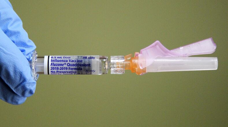 Influenza vaccine being prepared by Montgomery County Public Health Nurse Debbie Parker at their clinic in Dayton. TY GREENLEES / STAFF