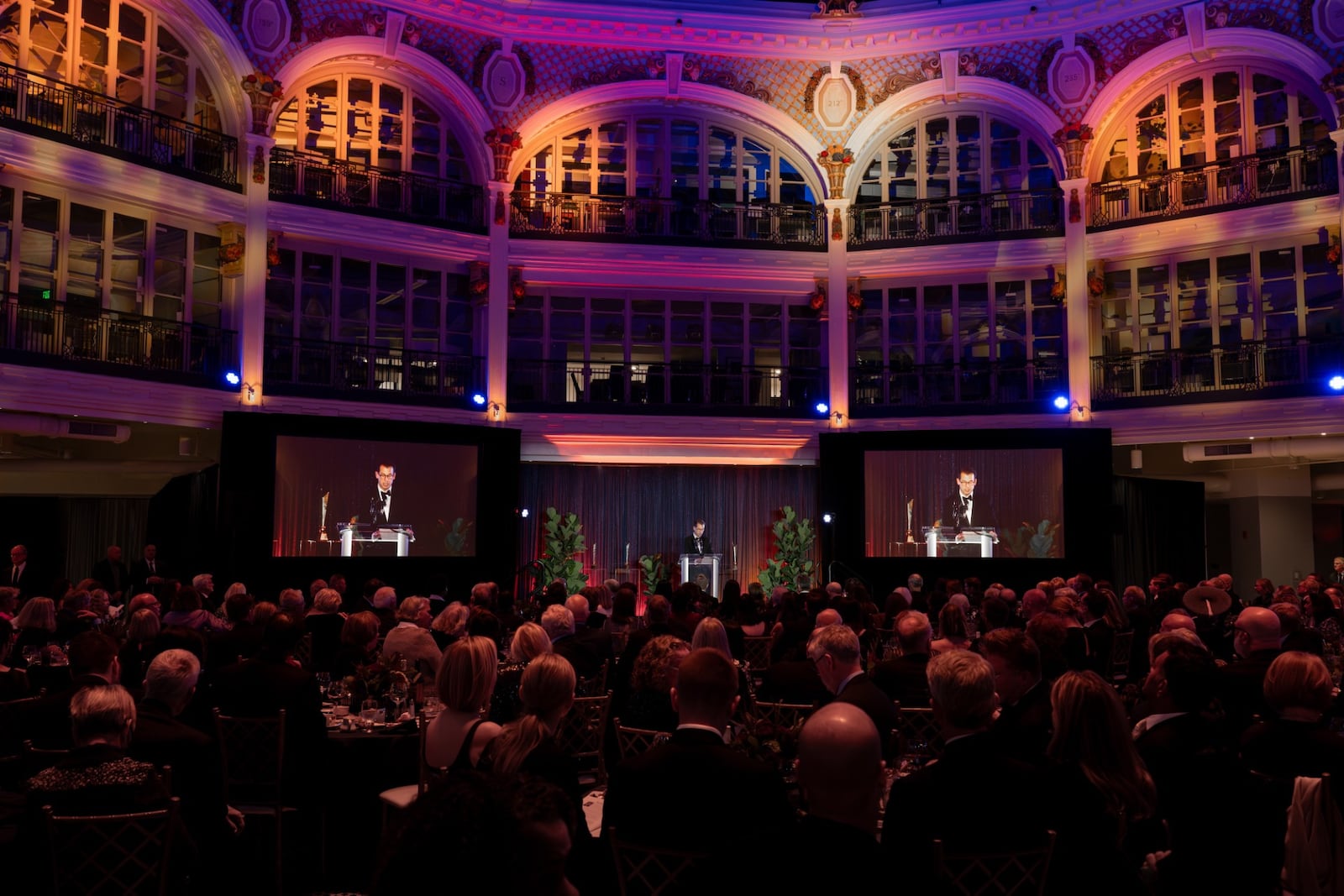 Executive Director Nicholas Raines gives opening remarks and Salman Rushdie gives his acceptance speech at the Nov. 9, 2025 Dayton Literary Peace Prize awards gala held in the rotunda of the Dayton Arcade. Chris Snyder / CONTRIBUTED