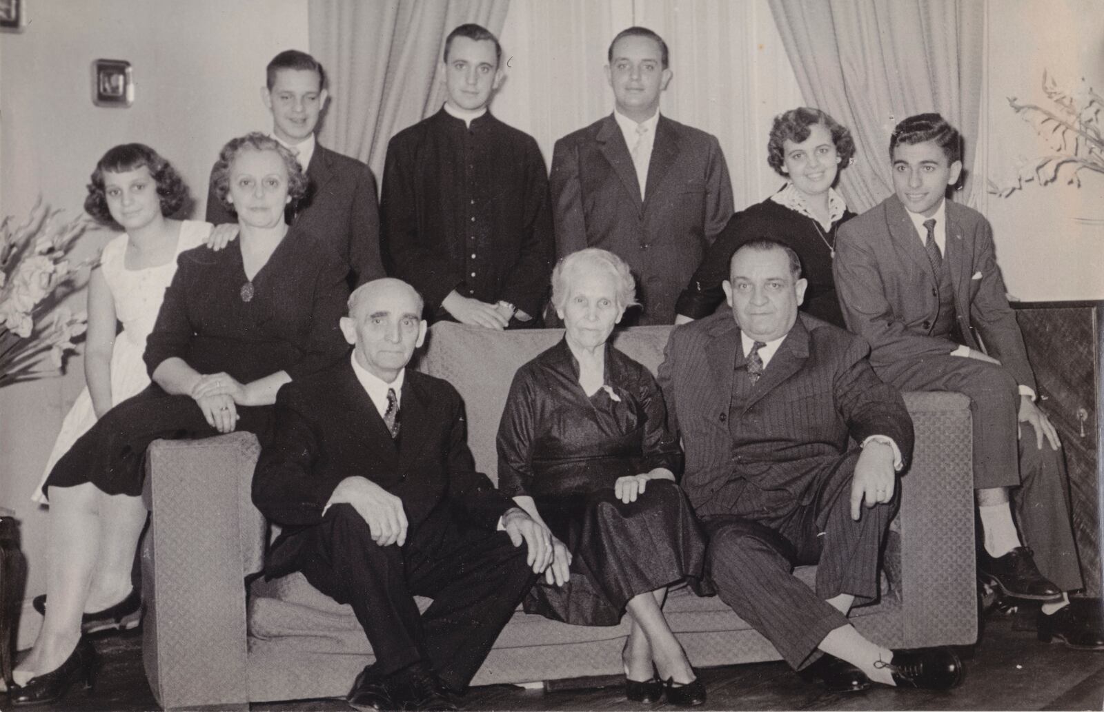 FILE - This undated handout reproduction of a photo made available by Maria Elena Bergoglio, shows the Bergoglio family as they pose for a portrait, in Buenos Aires, Argentina. Top row, from left; Maria Elena, Regina Sivori, Alberto, Jorge Mario, Oscar, Marta and her husband Enrique Navaja. Bottom row, from right; Mario, Maria de Bergoglio and Juan. Mario and Regina were the parents of Jorge Mario, Maria Elena, Oscar, Marta and Alberto. Juan and Maria were Mario Bergoglio's parents, Jorge Mario's paternal grandparents. (Bergoglio family photo via AP, File)