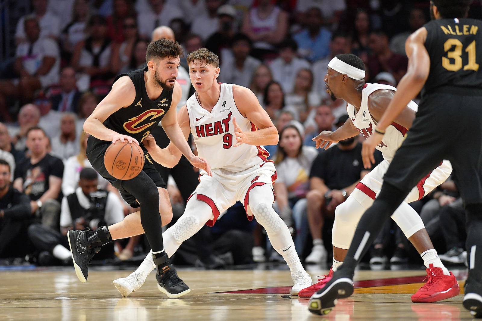 Miami Heat guard Pelle Larsson (9) guards Cleveland Cavaliers guard Ty Jerome during the first half in Game 3 of an NBA basketball first-round playoff series, Saturday, April 26, 2025, in Miami. (AP Photo/Michael Laughlin)