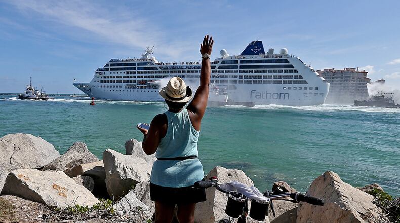 A woman from Cuba waves as Fathom cruise line’s Adonia moves up Government Cut enroute to Cuba past South Pointe Park on Miami Beach on Sunday, May 1, 2016. (Patrick Farrell/Miami Herald/TNS)