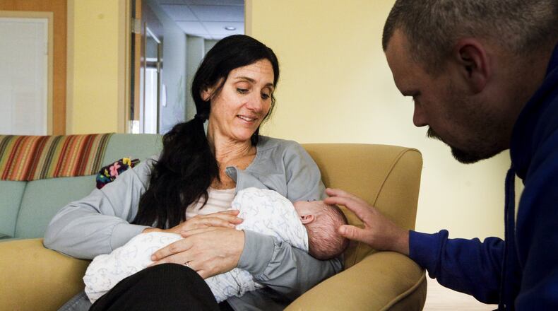 Shelly Decker, a nurse at Brigid’s Path, holds the first newborn treated for neonatal abstinence syndrome at the Kettering clinic. The boy went home with relative caregivers on Monday after spending 10 days at the facility that helps infants withdrawal from substances their mothers used while pregnant. CHRIS STEWART / STAFF