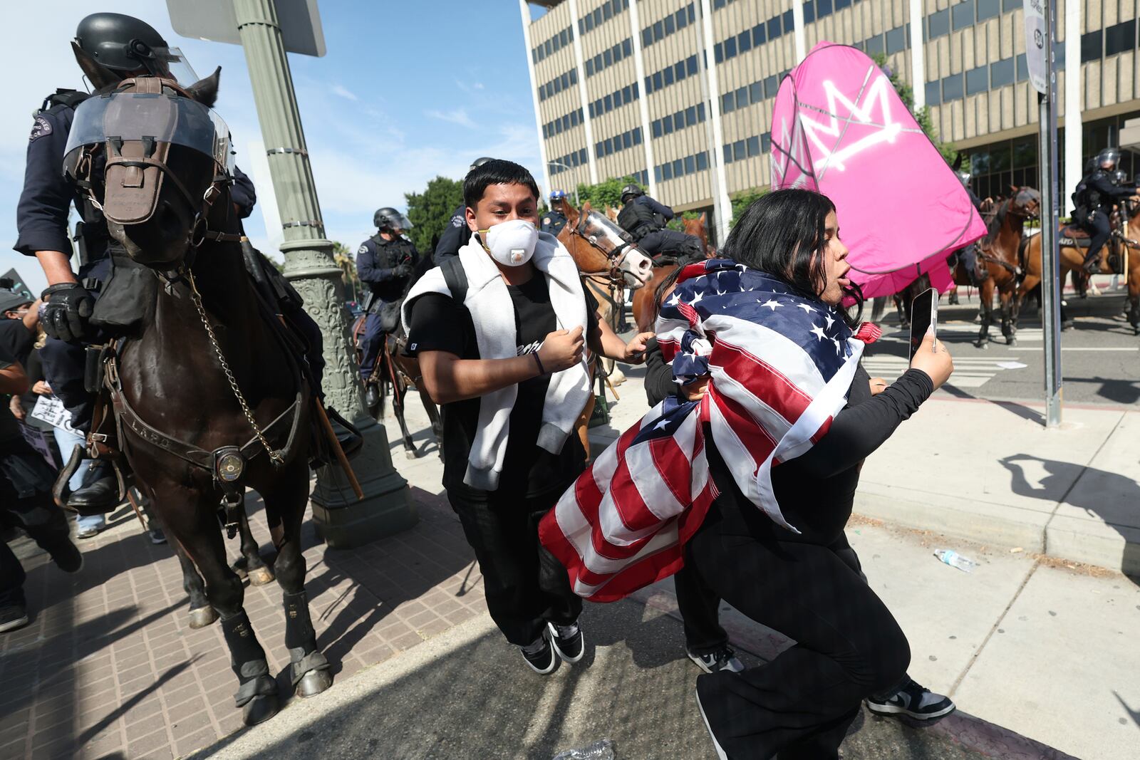 Law enforcement on horseback disperse demonstrators during a protest Saturday, June 14, 2025, in Los Angeles. (AP Photo/Ethan Swope)