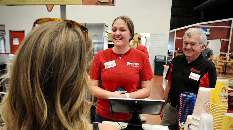 Megan Freeman, 19, stands with Dan Young at the Young's Jersey Dairy Thursday May 12, 2022. Freeman has worked for Young's for 4 seasons and said that she loves working there and that it's like working with family. MARSHALL GORBY\STAFF