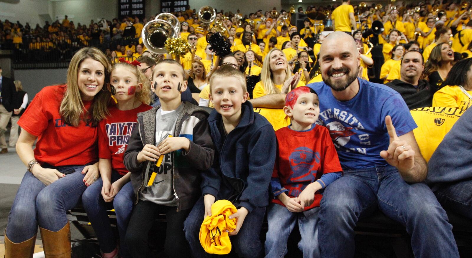 Dayton fans Krissi Morley, left, Addie Morley, Luke Betke, Easton Ogle, Jack Morley and Jeff Morley enjoy a front-row seat for a game against Virginia Commonwealth on Saturday, Feb. 28, 2015, at the Siegel Center in Richmond, Va. David Jablonski/Staff