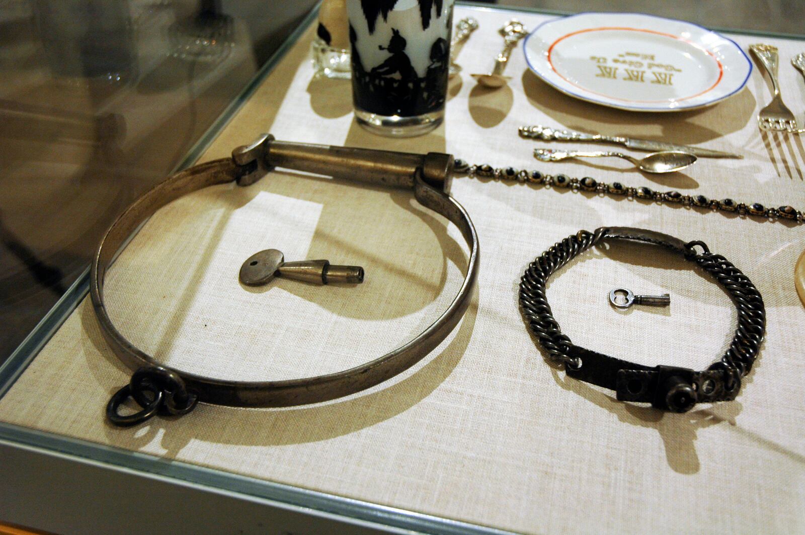 In this Jan. 11, 2018, photo, slave collars and a KKK plate, top right, are among the artifacts of slavery and segregation collected by Alan Page, NFL Hall of Famer and retired Minnesota Supreme Court justice, and his wife, Diane Sims Page. They went on display at the Minneapolis Central Library this month in time for Super Bowl visitors and thousands of other people expected to flock to downtown for the festivities. (AP Photo/Steve Karnowski)