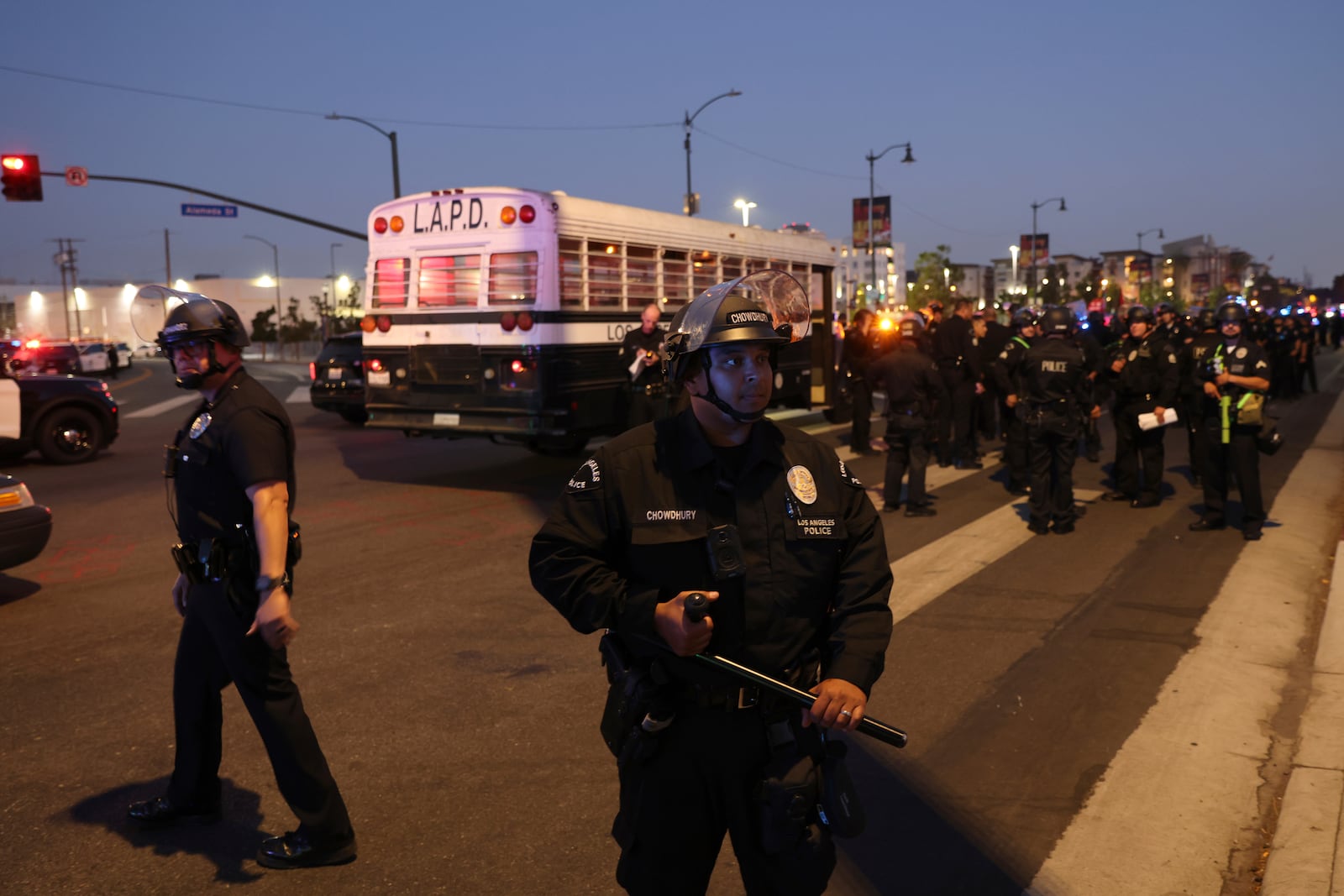 Los Angeles police officers stand by while protesters rally during a demonstration in response to a series of United States Immigration and Customs Enforcement (ICE) raids throughout the country, in Los Angeles, Calif., Thursday, June 12, 2025. (Gabrielle Lurie/San Francisco Chronicle via AP)