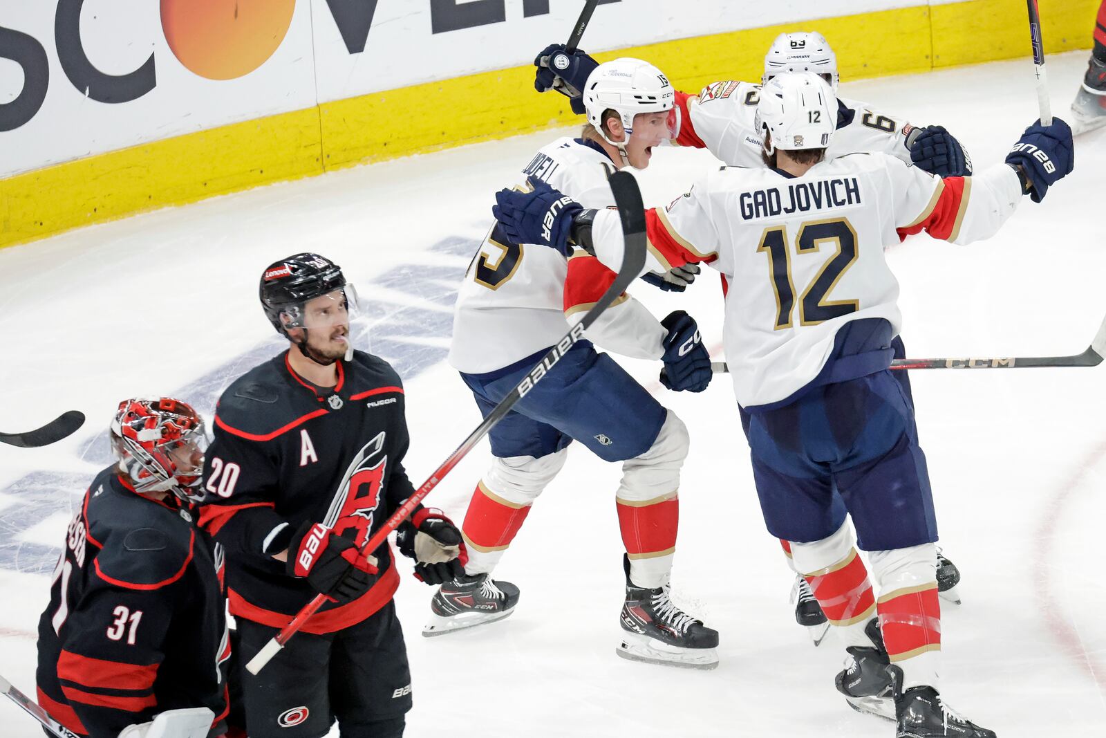 Florida Panthers center Anton Lundell (15) celebrates his goal with center Brad Marchand, top right, and left wing Jonah Gadjovich (12) while Carolina Hurricanes goaltender Frederik Andersen (31) and center Sebastian Aho (20) react during the second period in Game 5 of the NHL hockey Stanley Cup Eastern Conference finals Wednesday, May 28, 2025, in Raleigh, N.C. (AP Photo/Chris Seward)