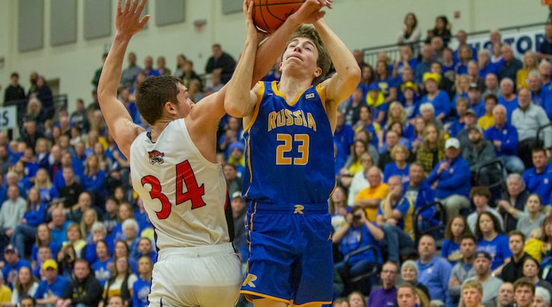 Russia's Benjamin York is fouled by Jackson Center's Camdyn Reese during Russia's 27-25 victory in the Region IV final at Trent Arena on Friday, March 10, 2023. CONTRIBUTED/Jeff Gilbert