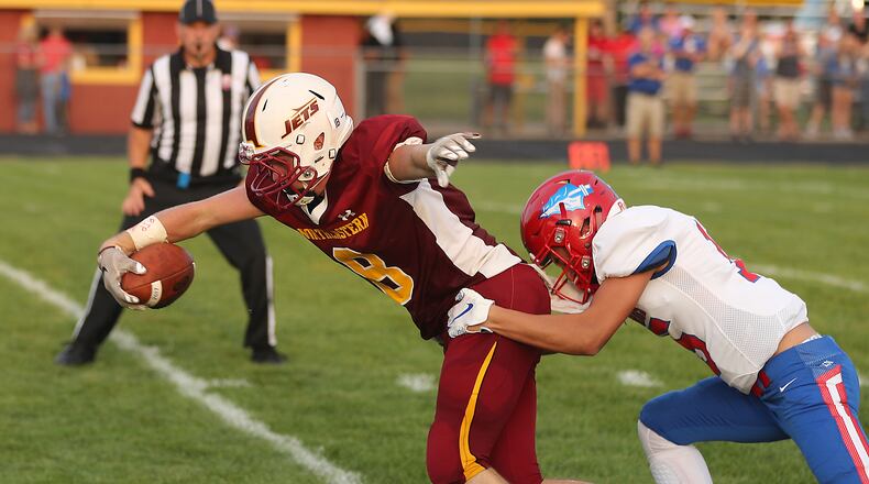 Northeastern's Frederick Michael Burns stretches into the end zone for a touchdown after catching a pass under pressure from Northwestern's Camron Smyczek.