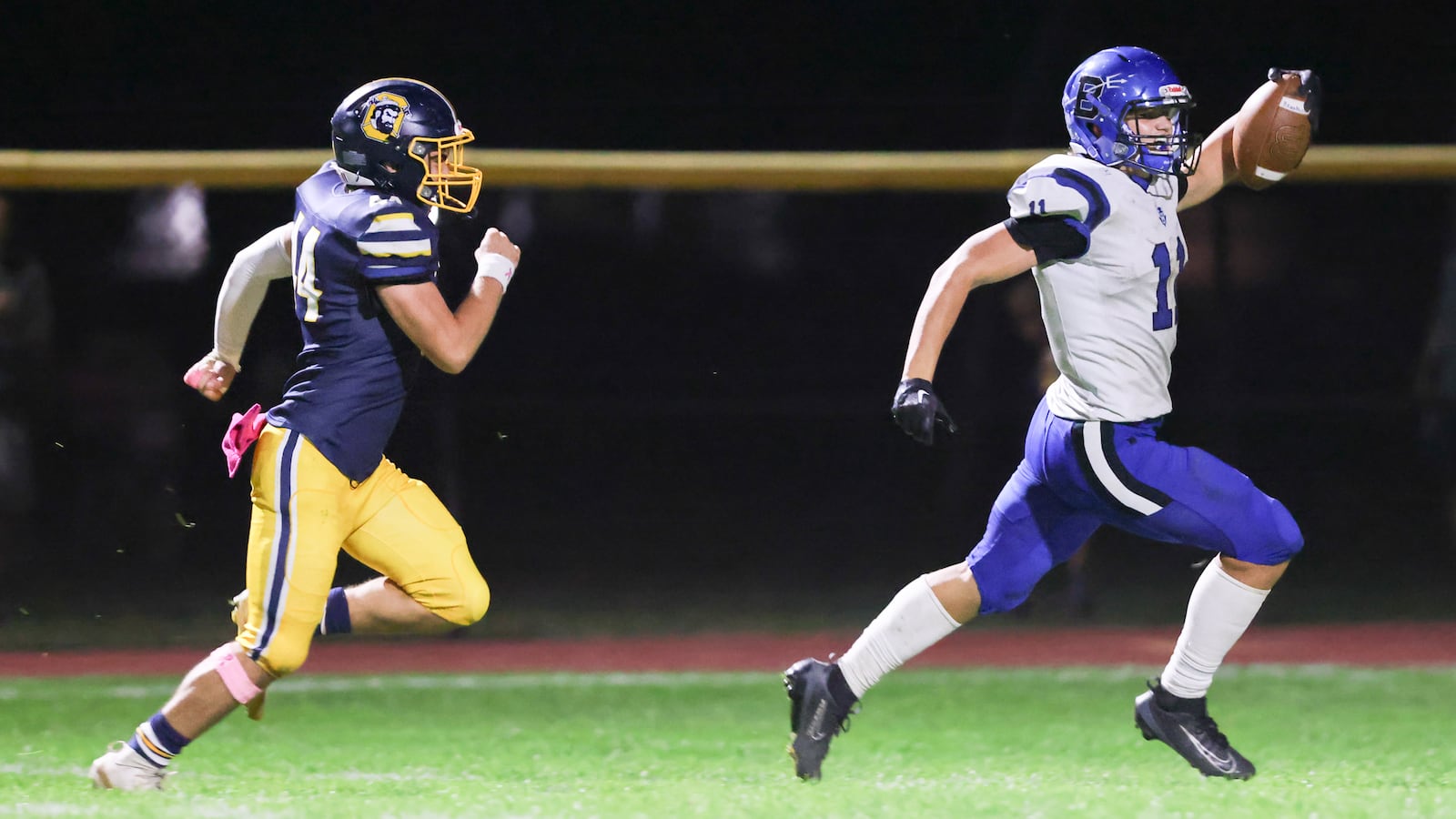 Brookville senior running back Aden Lamb holds out the ball as he nears the end zone while Oakwood's Owen Coyne trails during a 64-yard touchdown reception in the third quarter of a Southwestern Buckeye League game on Friday, Oct. 3  at Mack Hummon Stadium. BRYANT BILLING / STAFF