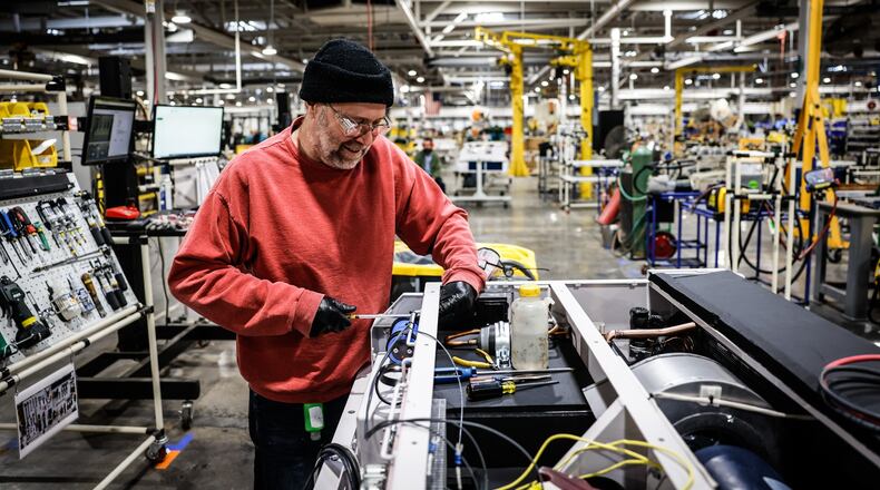 Phil Lyndower builds a HVAC for freight train engines at the Dayton Phoenix Group. JIM NOELKER/STAFF