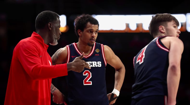 Dayton's Anthony Grant, left, talks to De'Shayne Montgomery in the second half against Bradley in the first round of the National Invitation Championship on Wednesday, March 18, 2026, at Carver Arena in Peoria, Ill. David Jablonski/Staff