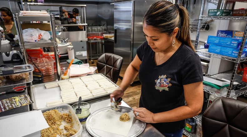 Catherine Roberts, owner of Lumpia Queen, makes lumpia at W. Social Tap & Table. JIM NOELKER/STAFF