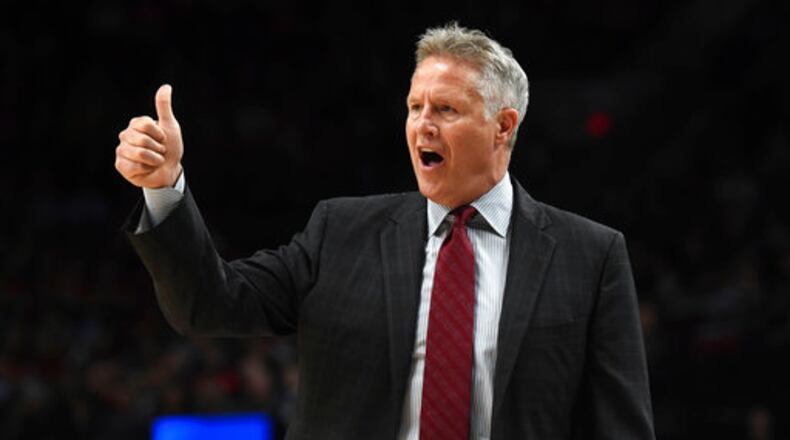 Philadelphia 76ers head coach Brett Brown signals to his team during the first half of an NBA basketball game against the Portland Trail Blazers in Portland, Ore., Thursday, March 9, 2017. (AP Photo/Steve Dykes)