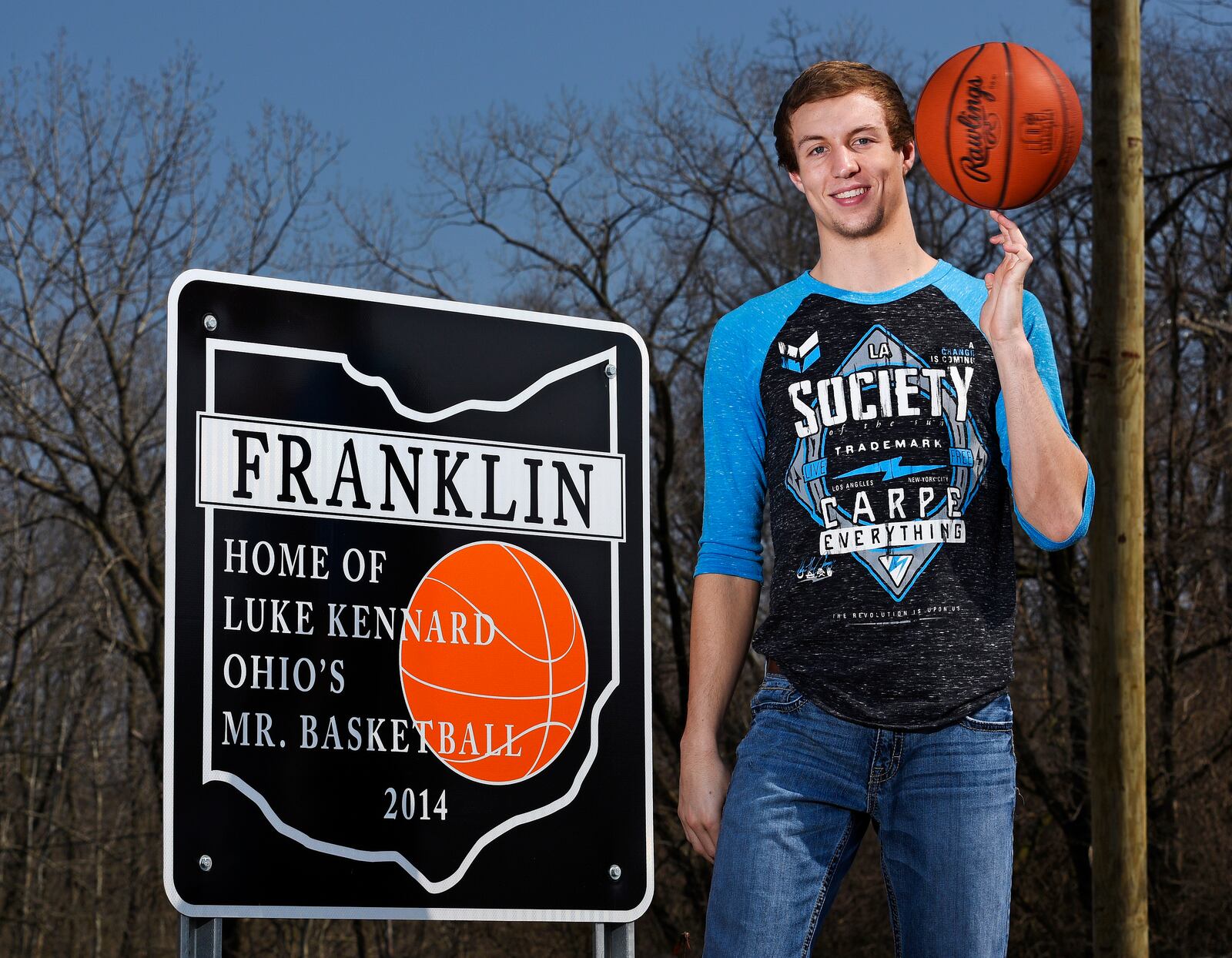 In this 2015 file photo, then-Franklin High School senior Luke Kennard stands next to one of the signs that were installed in Franklin honoring his Ohio Mr. Basketball honor. Around the time of the NBA draft, two of the five signs have been stolen forcing the city to take down the others. NICK GRAHAM/ STAFF