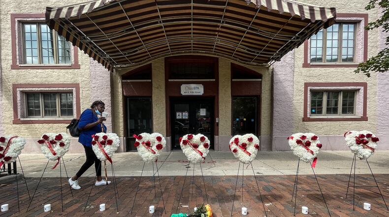 A women walks by a makeshift memorial of the nine people who where killed two years ago today in the Oregon District mass shooting in Dayton, Ohio. Jim Noelker/Staff