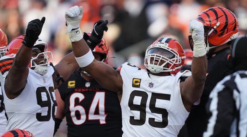 Cleveland Browns defensive end Myles Garrett (95) celebrates with defensive end Adin Huntington (98) after sacking Cincinnati Bengals quarterback Joe Burrow to set an NFL record for sacks in the regular season during the second half of an NFL football game, Sunday, Jan. 4, 2026, in Cincinnati. (AP Photo/Joshua A. Bickel)