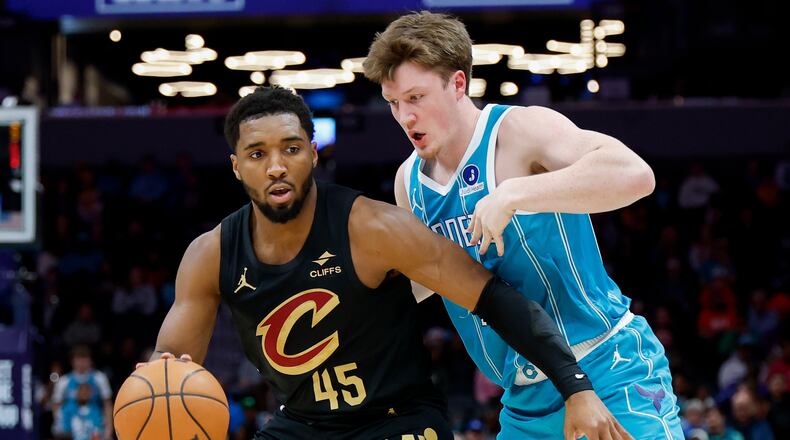 Cleveland Cavaliers guard Donovan Mitchell (45) moves the ball against Charlotte Hornets guard Kon Knueppel during the first half of an NBA basketball game in Charlotte, N.C., Wednesday, Jan. 21, 2026. (AP Photo/Nell Redmond)