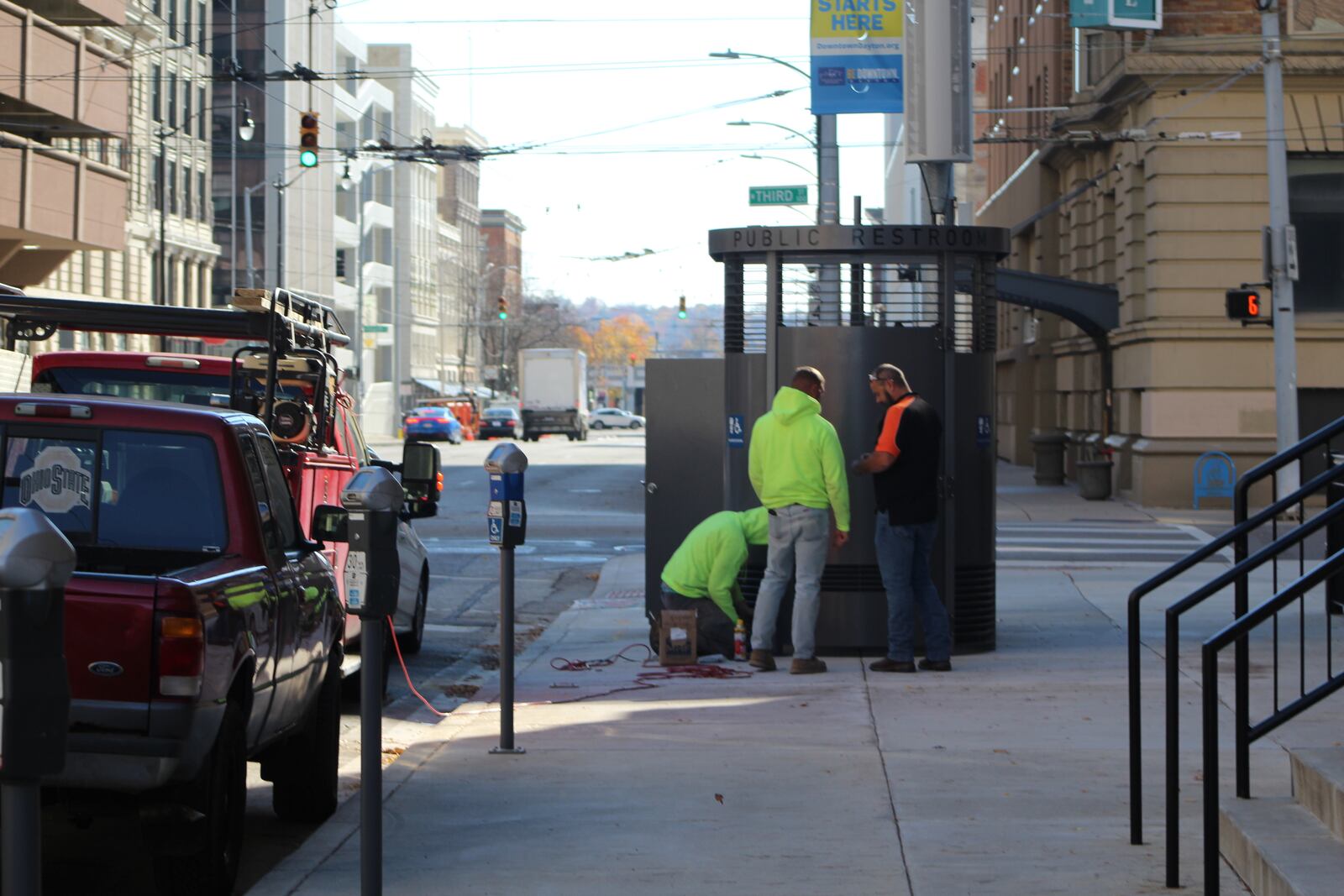 Crews install a Portland Loo near City Hall in downtown Dayton on Friday, Nov. 10, 2023. The quirky toilets have a unique design that limit privacy to prevent criminal activities. CORNELIUS FROLIK / STAFF