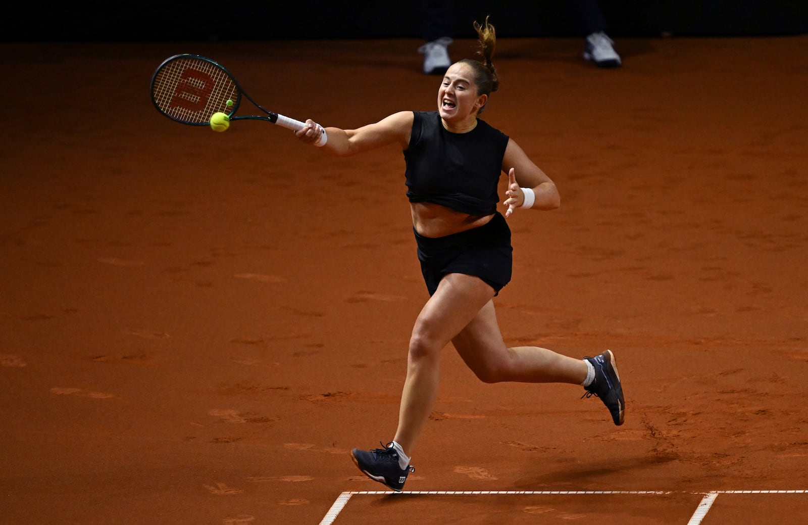 Jelena Ostapenko of Latvia in action against Aryna Sabalenka of Belarus during the women's singles final tennis match of the WTA tour, in Stuttgart, Germany, Moday, April 21, 2025. (Marijan Murat/dpa via AP)