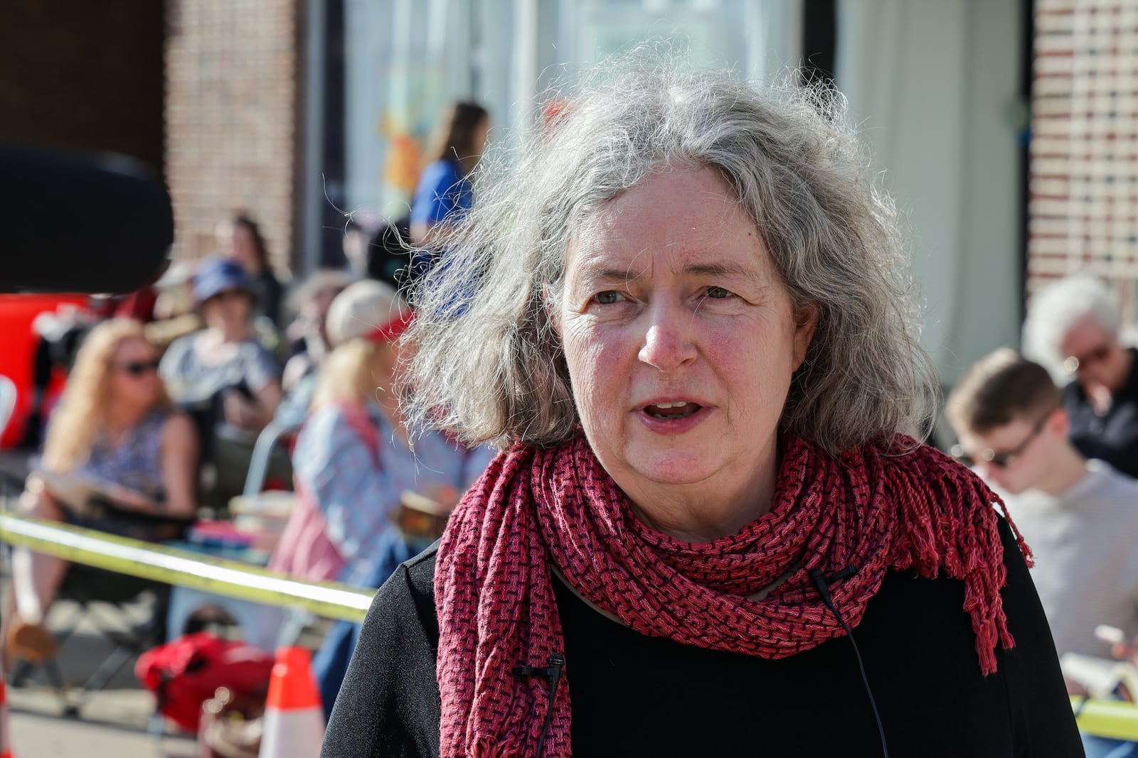 Rabbit Hole Books owner Larkin Vonalt talks to media during a "read-in" protest on Friday, March 6 in front of the store's West First Street location in downtown Dayton. The store, which was expecting to reopen on Friday after a fire last month, remains closed after city of Dayton inspectors shut down access to the building and surrounding sidewalk. BRYANT BILLING / STAFF
