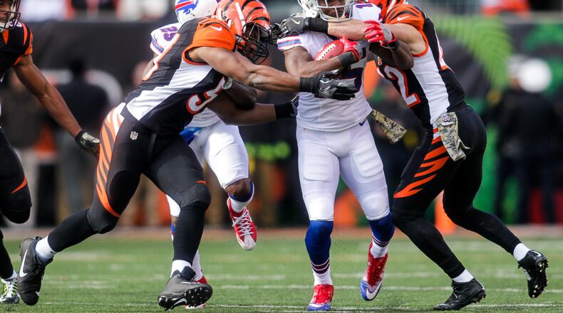Cincinnati Bengals linebacker Vincent Rey, left, and safety Clayton Fejedelem, right, take down Buffalo Bills wide receiver Brandon Tate during their 16-12 loss to the Buffalo Bills Sunday, Nov. 20, 2016, at Paul Brown Stadium in Cincinnati. NICK GRAHAM/STAFF