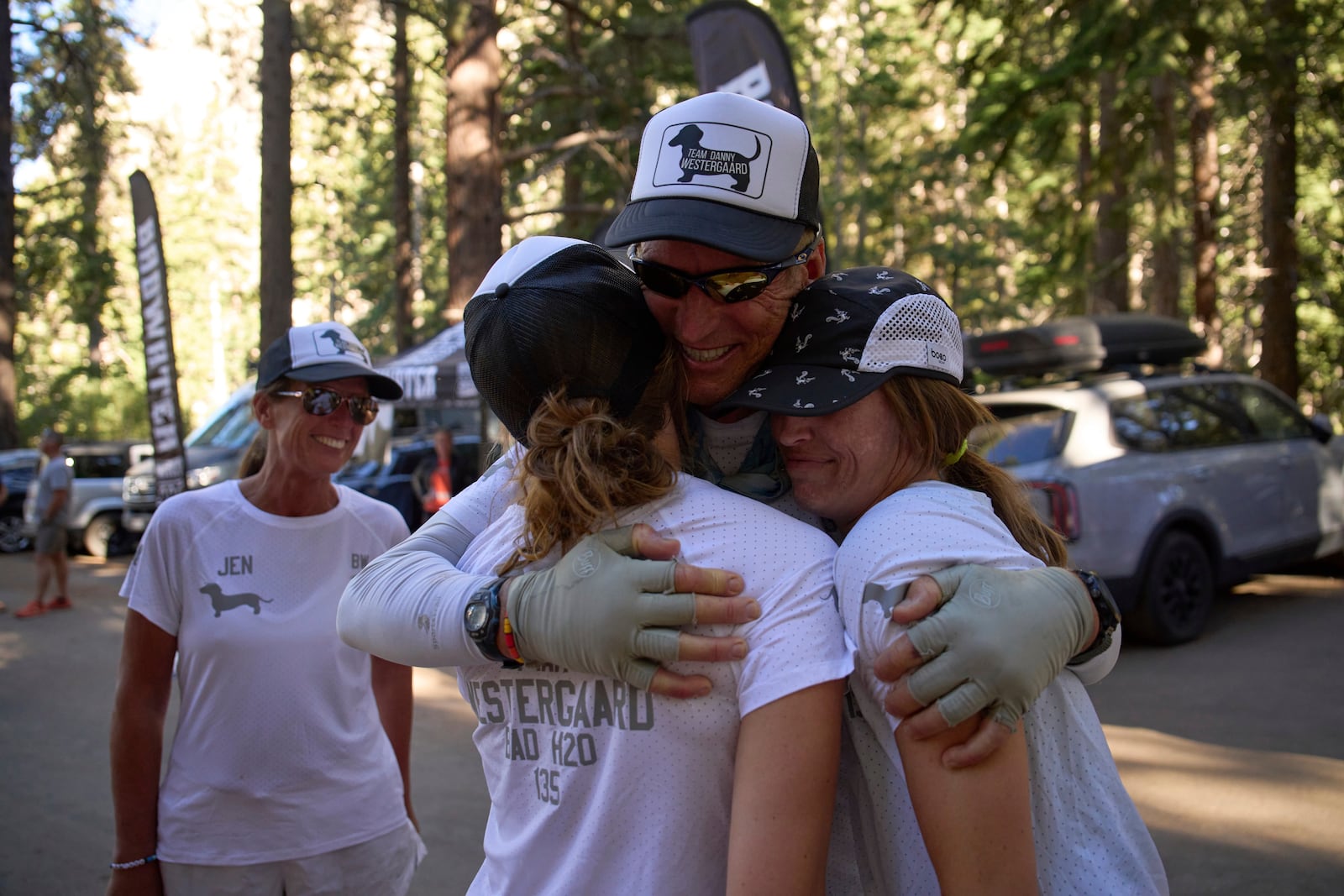 Danny Westergaard, second from right, embraces daughters Meagan Westergaard, right, and Madison Westergaard after finishing the Badwater 135 Ultramarathon, Wednesday, July 9, 2025, at Whitney Portal near Lone Pine, Calif. (AP Photo/John Locher)
