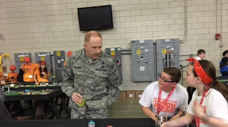 Two participants from Beavercreek explain the competition to Lt. Gen. Robert McMurry, Air Force Life Cycle Management Center commander. (U.S. Air Force photos/Marie Vanover)