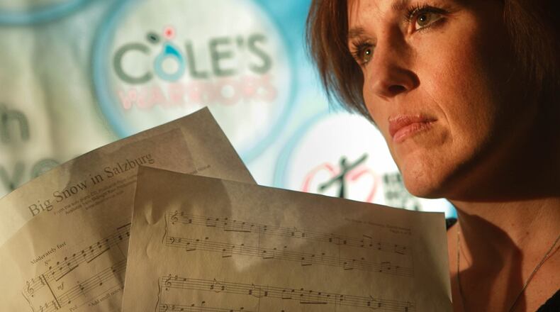 Danielle Smoot is the founder of Cole’s Warriors, a coalition she started through Family and Youth Initiatives in response to the prescription pill overdose death of her 16-year-old son Cole. She holds a special keepsakes of Cole’s: sheet music of the song Big Snow in Salzburg that he learned to play on the piano right before his death. JIM WITMER / STAFF