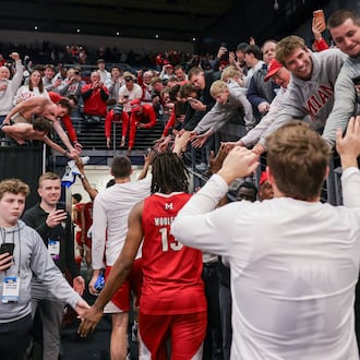 Miami fans cheer and clap hands with players following an 89-79 win over Southern Methodist in an NCAA First Four game on Wednesday, March 18 at University of Dayton Arena. BRYANT BILLING / STAFF
