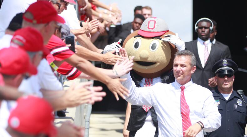 Ohio State's Urban Meyer walks to a game against Tulsa on Saturday, Sept. 10, 2016, at Ohio Stadium in Columbus. David Jablonski/Staff
