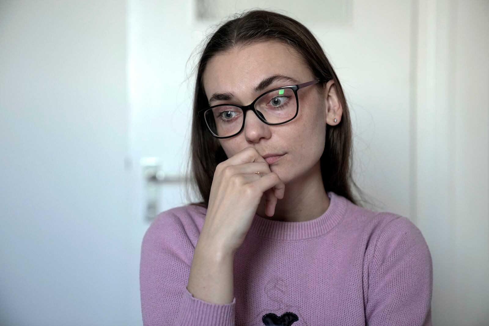 Liusiena Zinovkina, 32, sits in her room in Berlin, Germany, March 19, 2025. She fled to Germany from Ukraine, where her husband was arrested by invading Russian forces in May 2023. (AP Photo/Ebrahim Noroozi)
