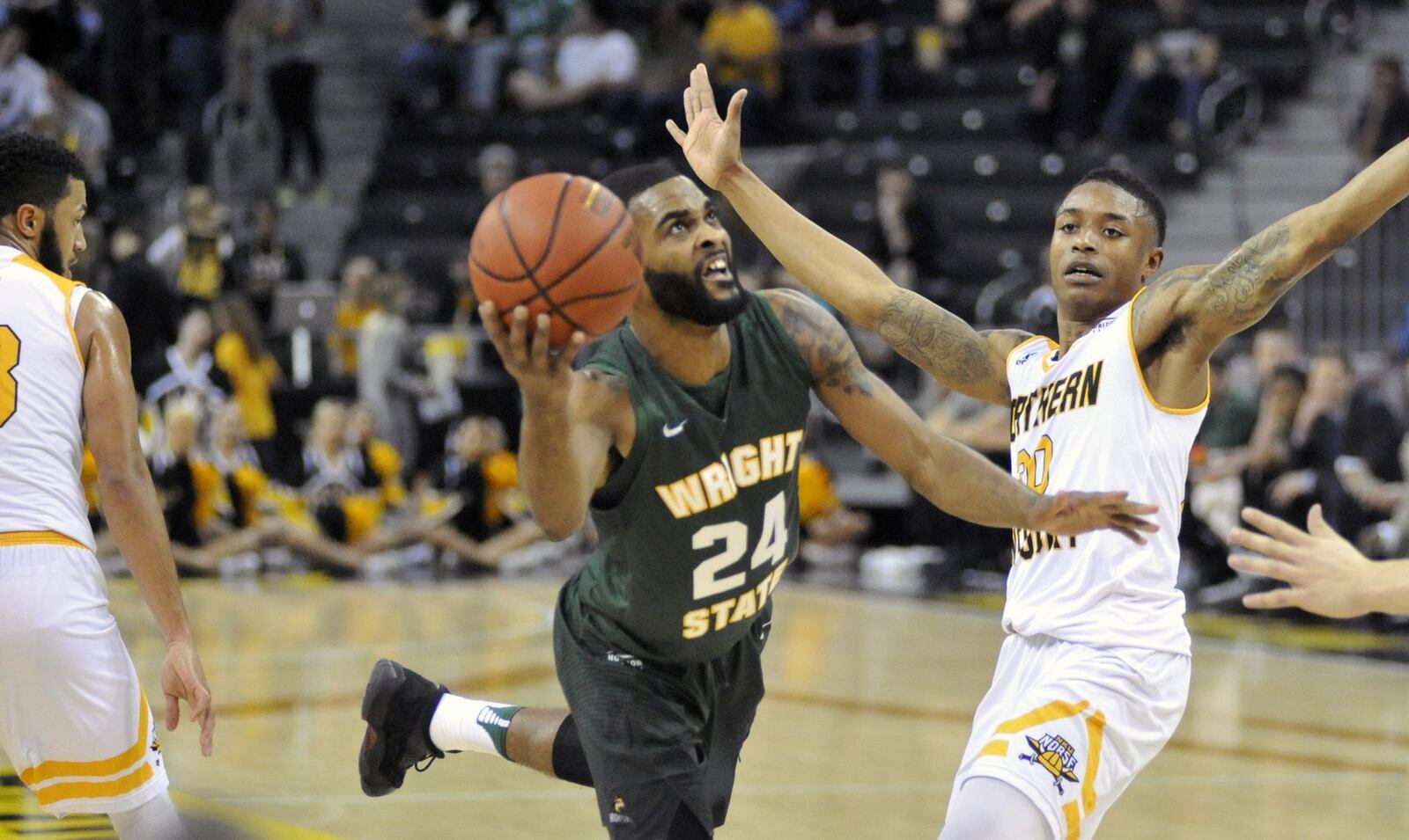 Wright State junior guard Mark Alstork puts up an off-balance shot in front of Northern Kentucky junior guard Lavone Holland II on Tuesday night at BB&T Arena.