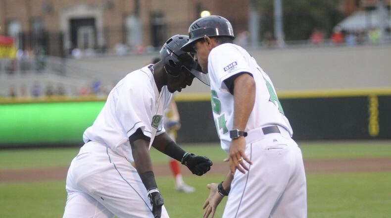 Dragons manager Luis Bolivar (right) congratulates Hector Vargas after a solo home run last season. MARC PENDLETON / STAFF