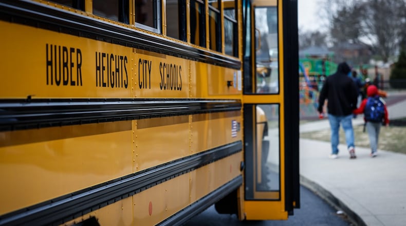 Students at Wright Brothers Elementary head to the bus for a ride home Tuesday December 13, 2022. Schools across the region are still struggling to cover bus routes including Huber Heights schools. JIM NOELKER/STAFF