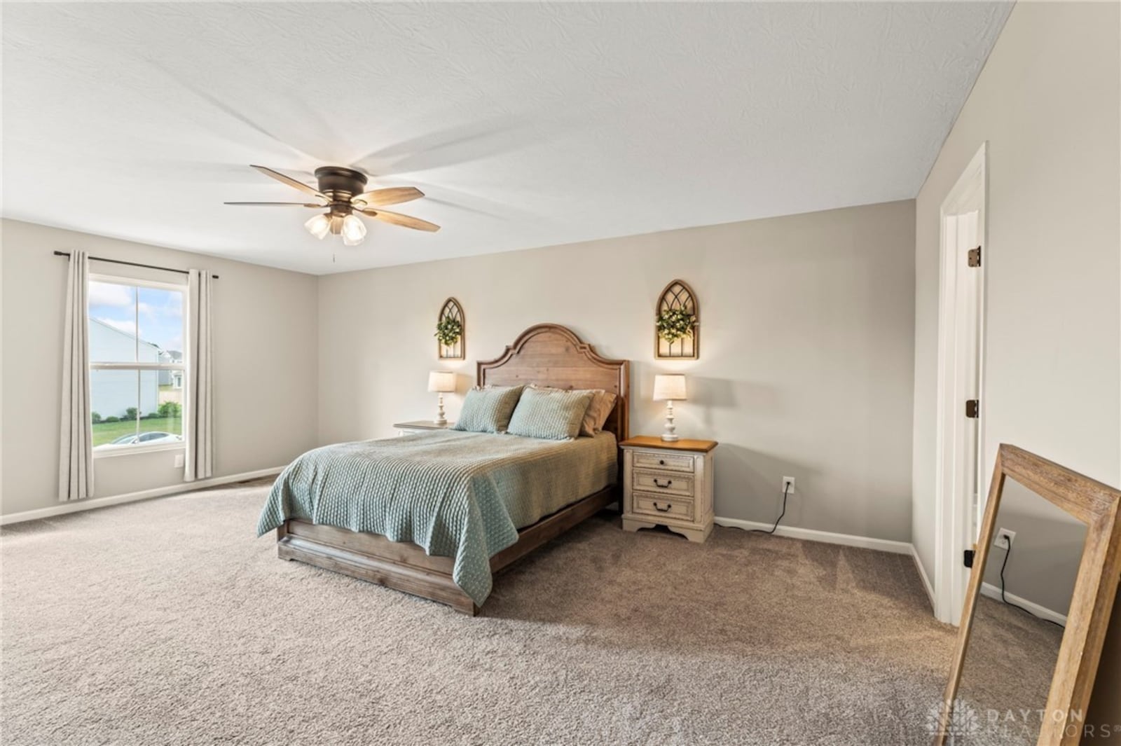 The second floor primary bedroom suite has a ceiling fan and neutral carpeting. There is also a walk in closet and ensuite bathroom with shower and garden tub. CONTRIBUTED