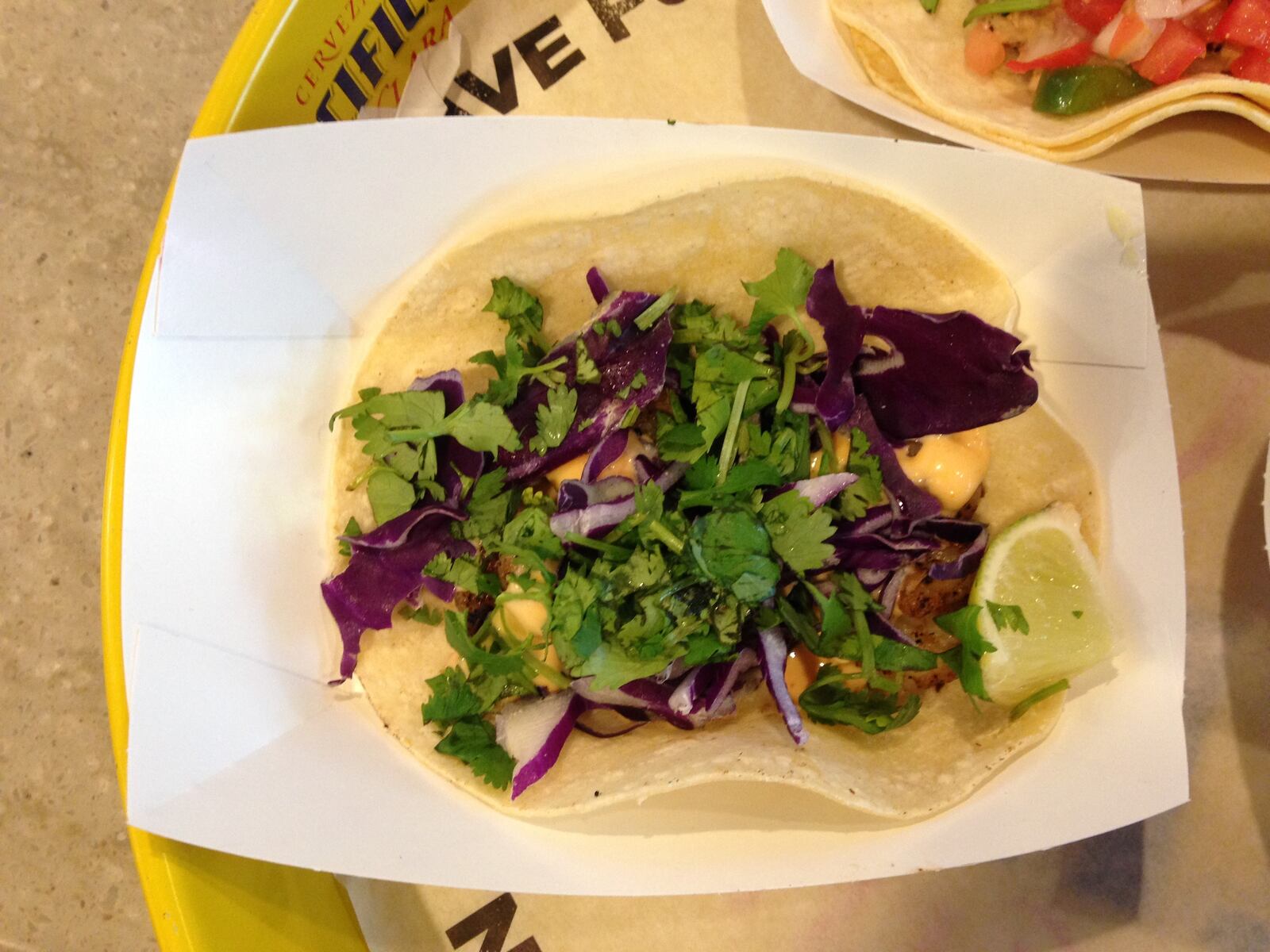 R Taco's baja shrimp tacos feature crispy or grilled shrimp topped with creamy baja sauce, red cabbage and cilantro.