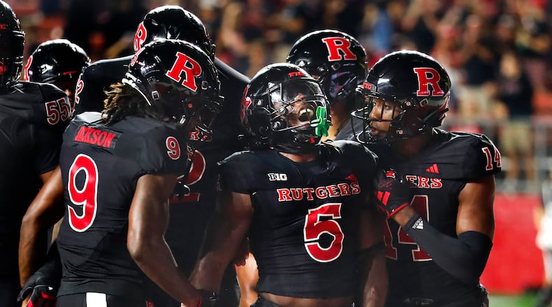 Rutgers running back Kyle Monangai (5) celebrates with wide receivers JaQuae Jackson (9) and Isaiah Washington (14) after scoring a touchdown against Temple during the second half of an NCAA college football game Saturday, Sept. 9, 2023, in Piscataway, N.J. (AP Photo/Noah K. Murray)