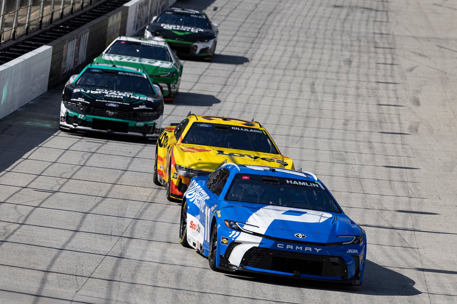 Denny Hamlin (11) leads Todd Gilliland (34) during a NASCAR Cup Series auto race, Sunday, April 13, 2025, in Bristol, Tenn. (AP Photo/Wade Payne)