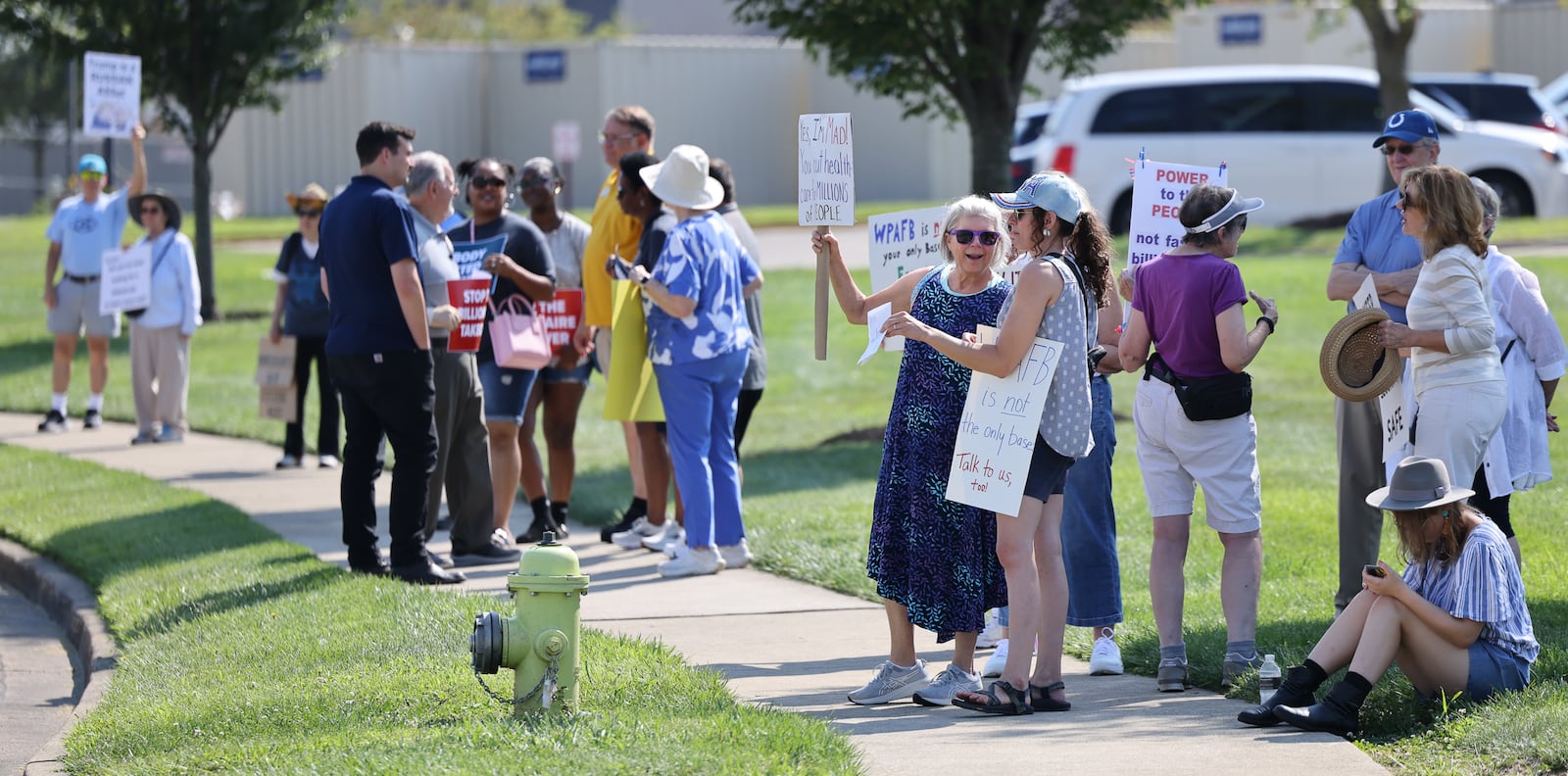 Demonstrators gathered on Thursday on the sidewalk along Presidential Drive in Fairborn near Wright State University in front of a DoubleTree by Hilton that U.S. Rep. Mike Turner (R-Dayton) was scheduled to speak at during a meeting with a defense trade group. Demonstrators were holding signs criticizing Turner for not hosting town halls or public meetings. BRYANT BILLING / STAFF